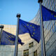 EU flags in front of European Commission building in Brussels