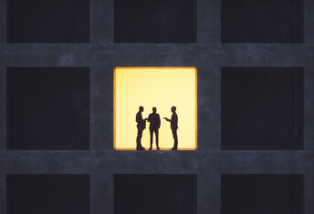 Businessmen talking in secrecy.