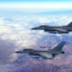 Two fighter jets flying together above clouds over Europe