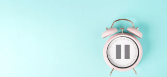 Alarm clock with pause sign, take a break, menopause concept, hormone replacement therapy