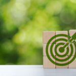 Environmental goals of green business Business development strategy with sustainable environmental conservation wooden block on handle With a green target icon. copy space