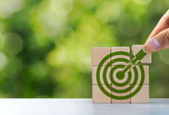 Environmental goals of green business Business development strategy with sustainable environmental conservation wooden block on handle With a green target icon. copy space
