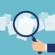 Illustration of a magnifying glass examining documents