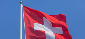 https://www.gettyimages.co.uk/detail/photo/flag-of-switzerland-against-clear-blue-sky-on-a-royalty-free-image/1031668640?phrase=swiss+flag