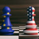 USA and EU cooperation concept. US America and European Union flags on chess pawns soldiers on a chessboard. 3d illustration